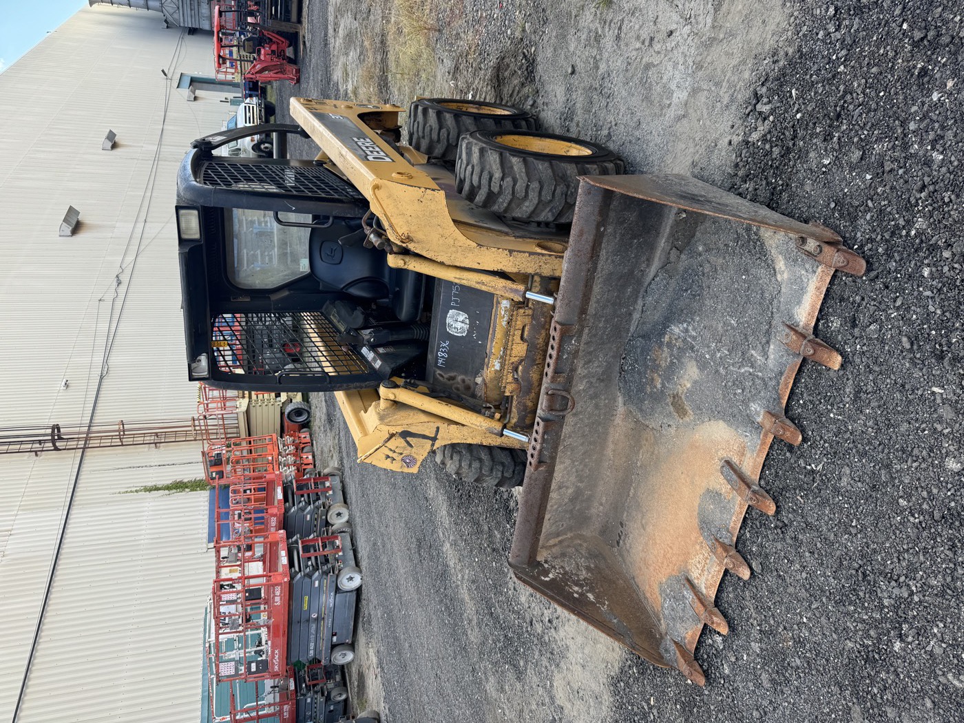 John Deere skid steer with bucket, ready to work